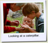 Grandma, Taylor and Heather looking at a caterpillar.