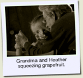 Grandma and Heather squeezing a grapefruit.